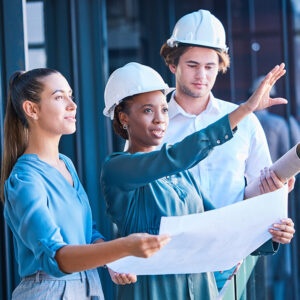 Diverse construction workers talking and reviewing plans